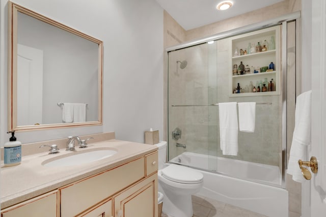 full bathroom with vanity, tile patterned flooring, toilet, and combined bath / shower with glass door