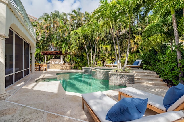 view of pool featuring an in ground hot tub, an outdoor bar, and a patio area