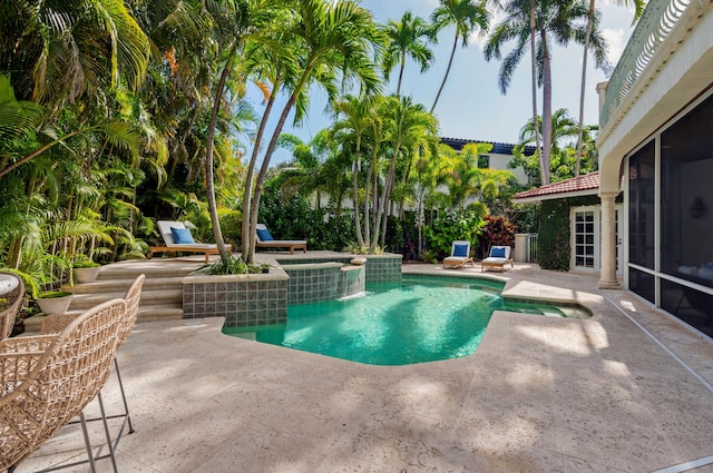 view of swimming pool with a patio area and an in ground hot tub