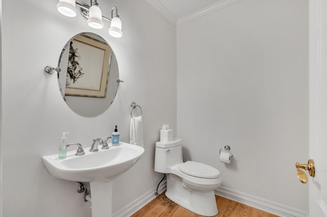 bathroom with ornamental molding, hardwood / wood-style floors, and toilet