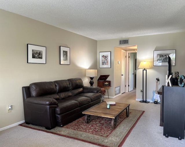 carpeted living room with a textured ceiling