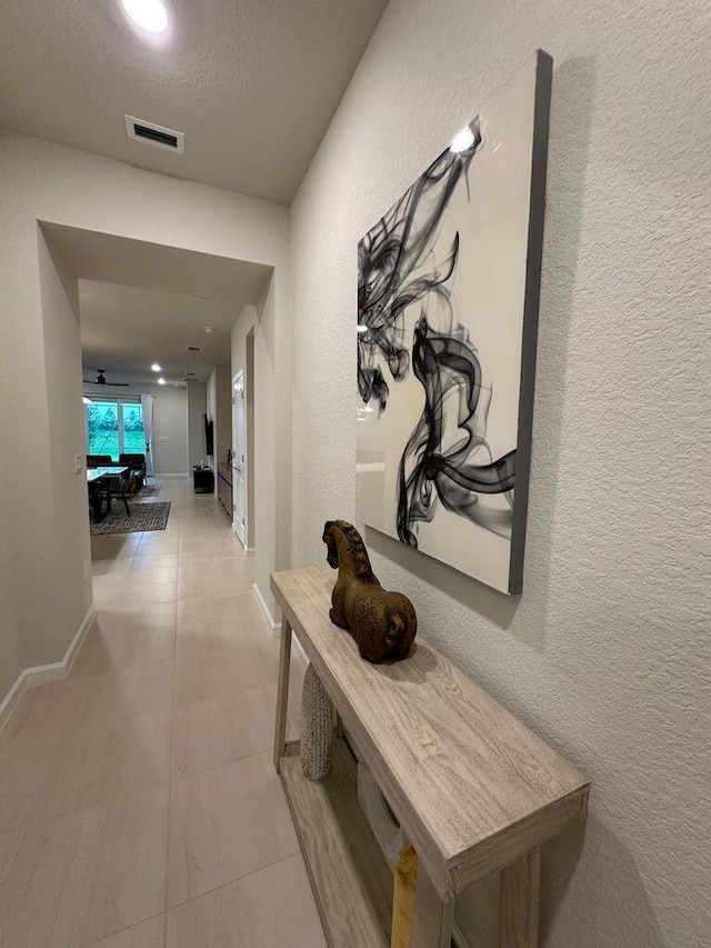 hallway featuring a textured ceiling