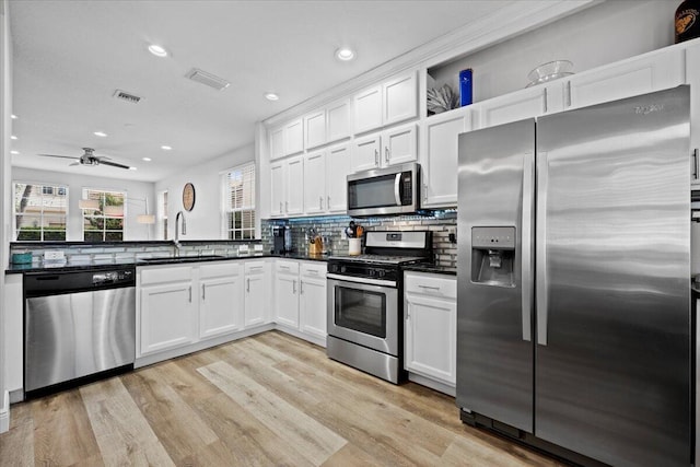 318 September St, Palm Beach Gardens, FL 33410 - kitchen featuring stainless steel appliances, a sink, recessed lighting, backsplash, and light wood finished floors