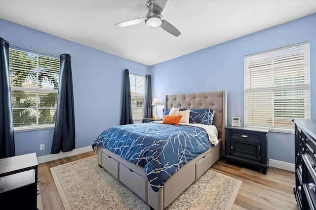 bedroom with ceiling fan and light hardwood / wood-style floors