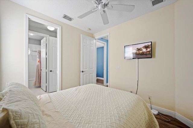 bedroom with a textured ceiling, ceiling fan, and light hardwood / wood-style flooring