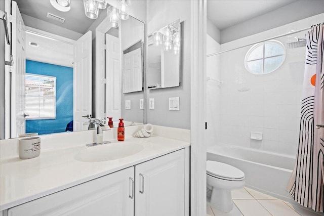 full bathroom featuring vanity, tile patterned floors, toilet, and shower / bath combo with shower curtain