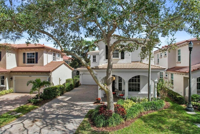 318 September St, Palm Beach Gardens, FL 33410 - mediterranean / spanish-style house featuring a tiled roof, a garage, stucco siding, and driveway
