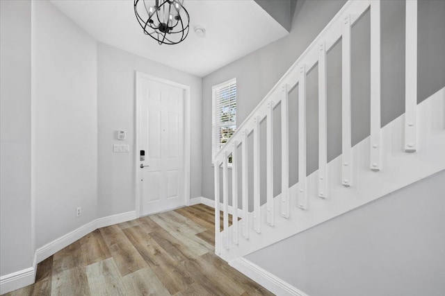 entrance foyer with a chandelier and light hardwood / wood-style floors