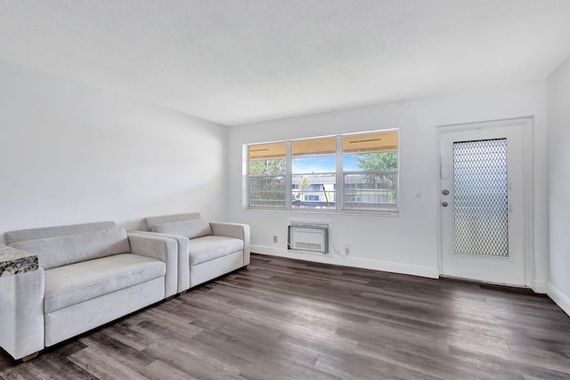 unfurnished living room featuring dark wood-type flooring