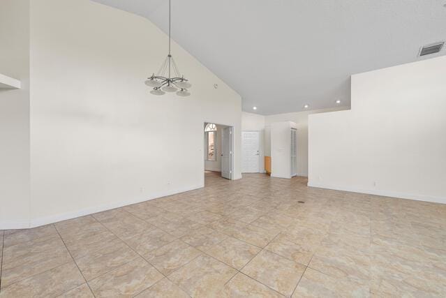 interior space with high vaulted ceiling and a chandelier