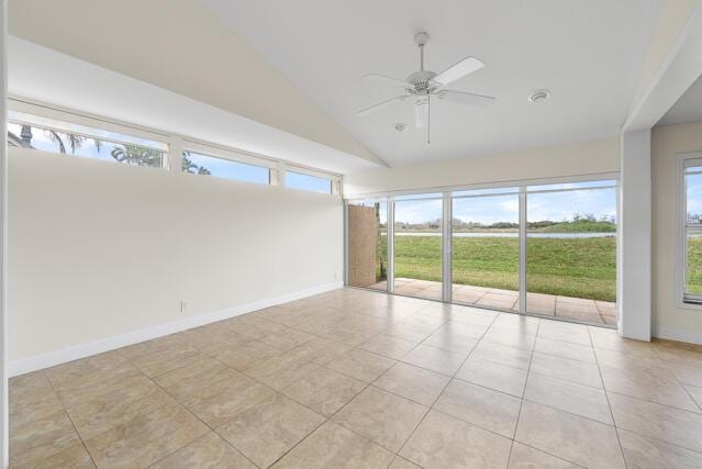 tiled empty room featuring ceiling fan and high vaulted ceiling