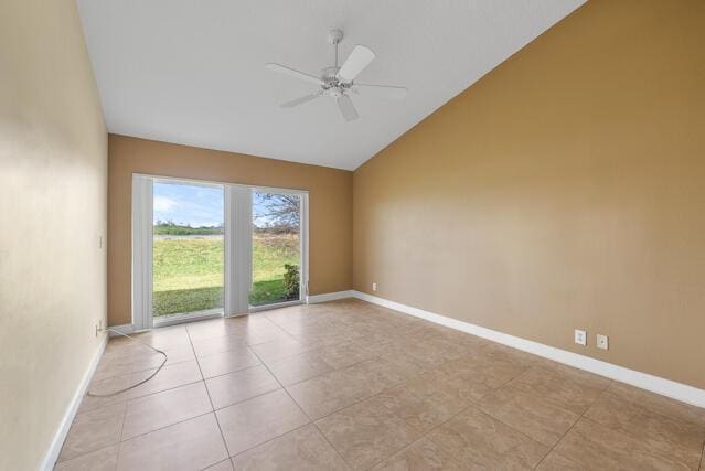 empty room with light tile patterned flooring, ceiling fan, and high vaulted ceiling