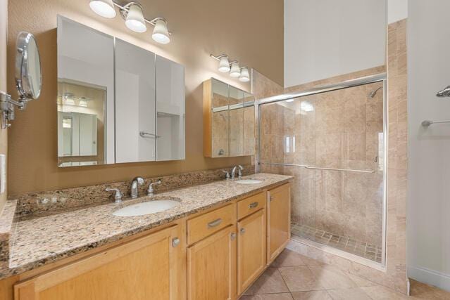 bathroom with tile patterned floors, vanity, and an enclosed shower