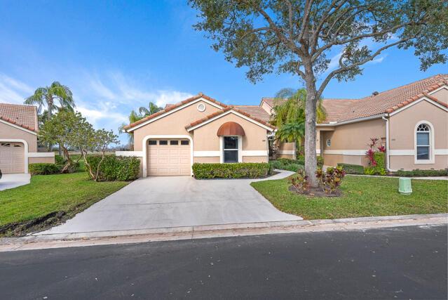 view of front of property featuring a garage and a front lawn