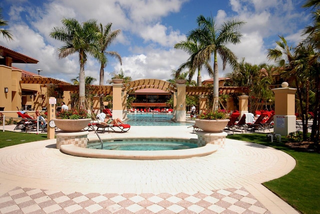 view of swimming pool featuring a hot tub