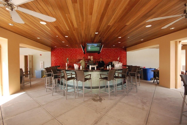 bar with wood ceiling, ceiling fan, and light tile patterned floors