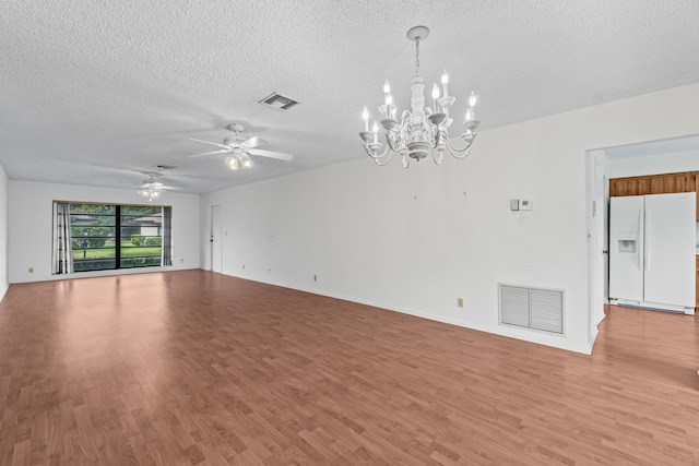 10439 Quailwood Ln Unit B, Boynton Beach, FL 33436 - unfurnished living room featuring a textured ceiling, a chandelier, light wood-style flooring, ceiling fan, and baseboards