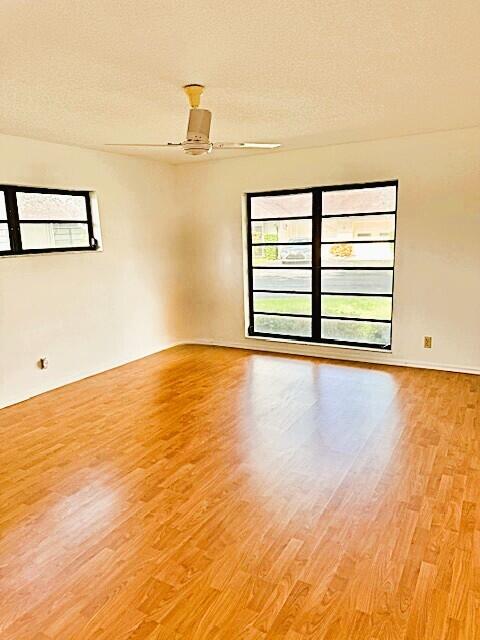 10439 Quailwood Ln Unit B, Boynton Beach, FL 33436 - unfurnished room with light wood finished floors, plenty of natural light, and a ceiling fan