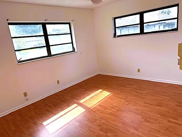 10439 Quailwood Ln Unit B, Boynton Beach, FL 33436 - unfurnished room with healthy amount of natural light and light wood finished floors
