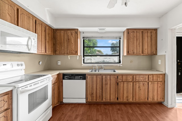 10439 Quailwood Ln Unit B, Boynton Beach, FL 33436 - kitchen with white appliances, a sink, brown cabinets, light countertops, and dark wood-type flooring