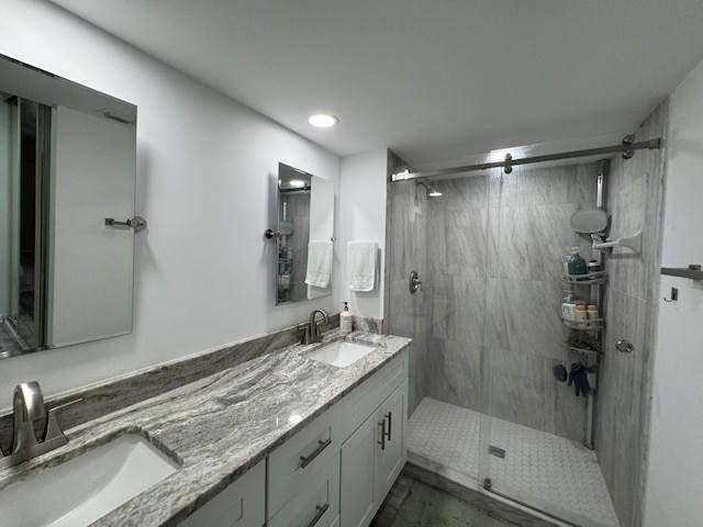 full bath featuring recessed lighting, double vanity, a stall shower, and a sink