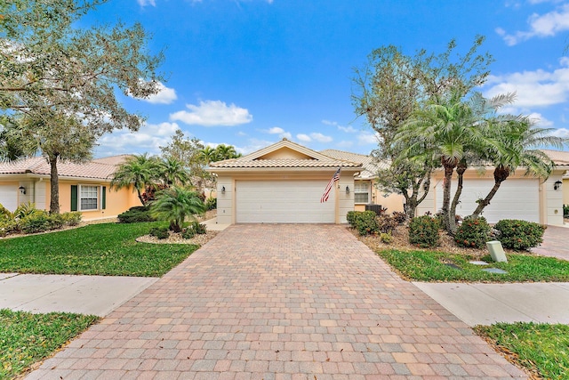 view of front of property with a front lawn and a garage