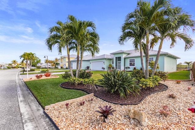 view of front of property with a garage and a front yard