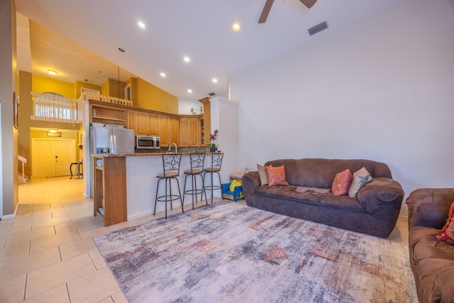 tiled living room with high vaulted ceiling, sink, and ceiling fan