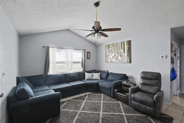 tiled living room featuring lofted ceiling, a textured ceiling, a ceiling fan, and a textured wall