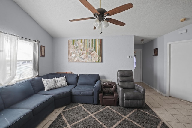 living area with lofted ceiling, light tile patterned floors, and a textured ceiling