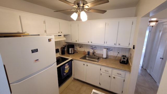 kitchen featuring white cabinetry, sink, white appliances, and light tile patterned floors