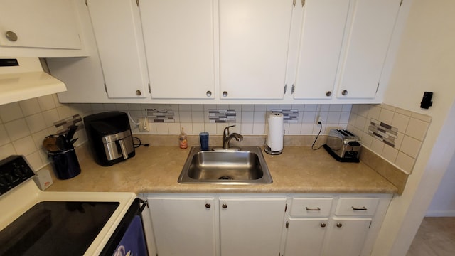 kitchen featuring range with electric cooktop, range hood, sink, white cabinets, and backsplash