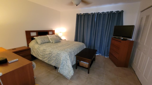 tiled bedroom featuring a closet