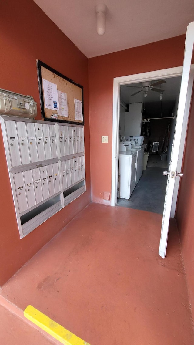 view of home's community featuring mail boxes and washer and clothes dryer