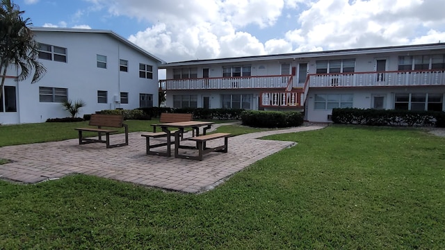 view of home's community with a yard and a patio