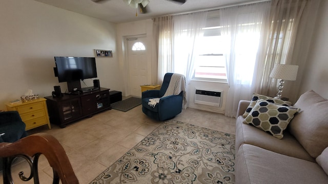 tiled living room with ceiling fan and an AC wall unit