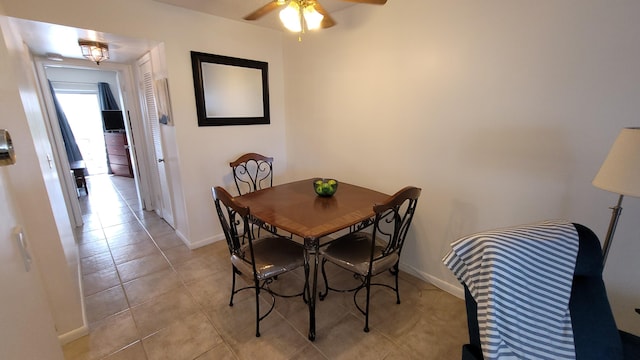 dining space with light tile patterned flooring and ceiling fan