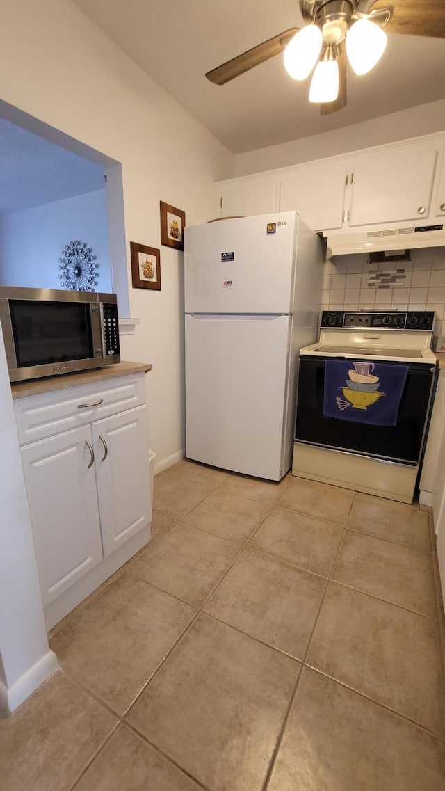 kitchen with electric stove, decorative backsplash, white cabinets, and white fridge