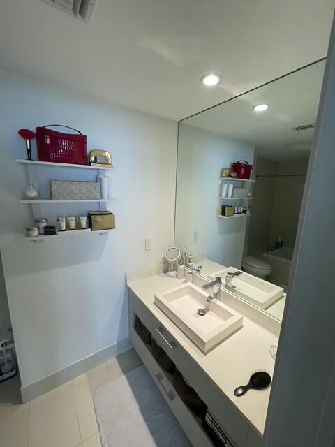 full bathroom with vanity, toilet, and shower / washtub combination