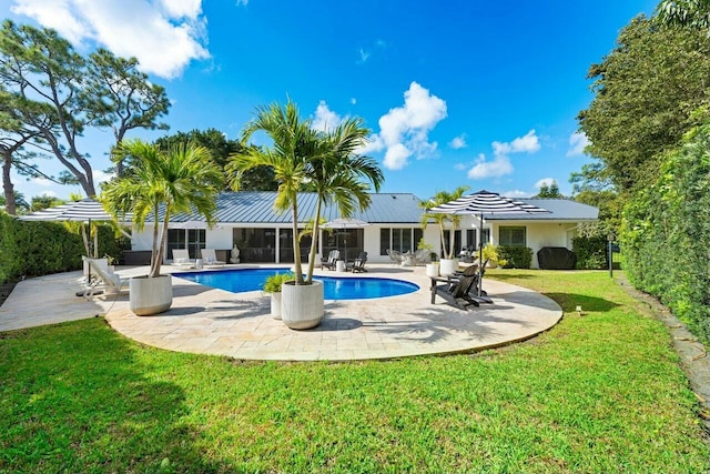 back of property featuring a yard, solar panels, and a patio area