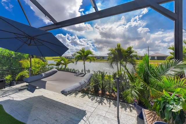 surrounding community featuring a patio area and a water view