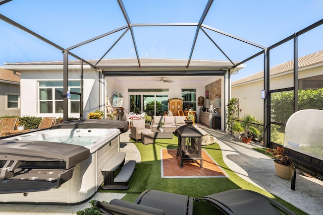 exterior space featuring a jacuzzi, a ceiling fan, and an outdoor hangout area