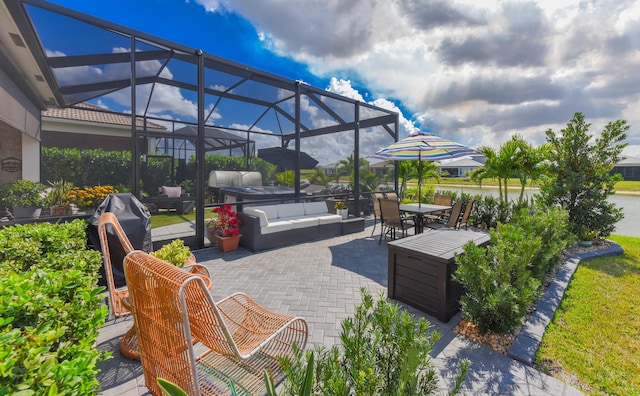 view of patio / terrace with an outdoor hangout area, glass enclosure, and outdoor dining area