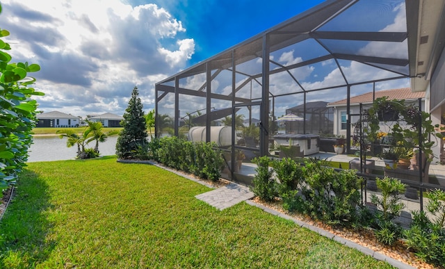 view of green lawn featuring a lanai, a water view, a patio area, and a residential view