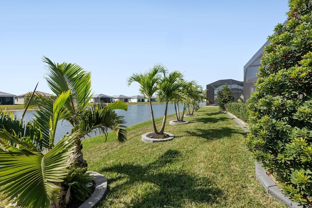 view of community featuring a yard, a water view, and a residential view
