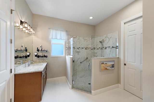 full bath featuring a marble finish shower, vanity, baseboards, and tile patterned floors