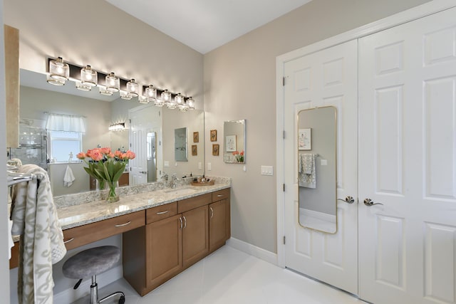 bathroom featuring tile patterned floors, vanity, and baseboards
