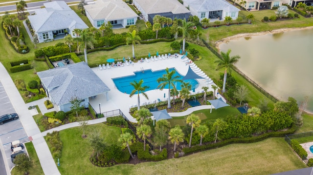 aerial view of residential area with a pool and a nearby body of water