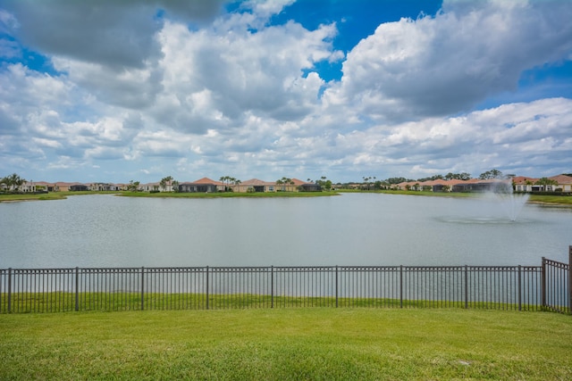 water view featuring fence and nearby suburban area