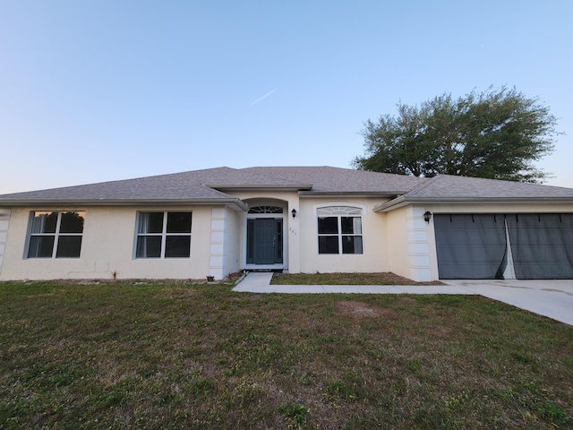 single story home featuring an attached garage, concrete driveway, a front yard, and stucco siding